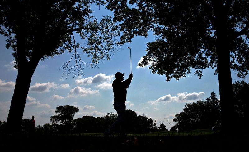 Michael Putnam hits a shot under trees during the Nationwide Children's Hospital Invitational on July 27, 2012, at The Ohio State University Golf Club Scarlet Course.