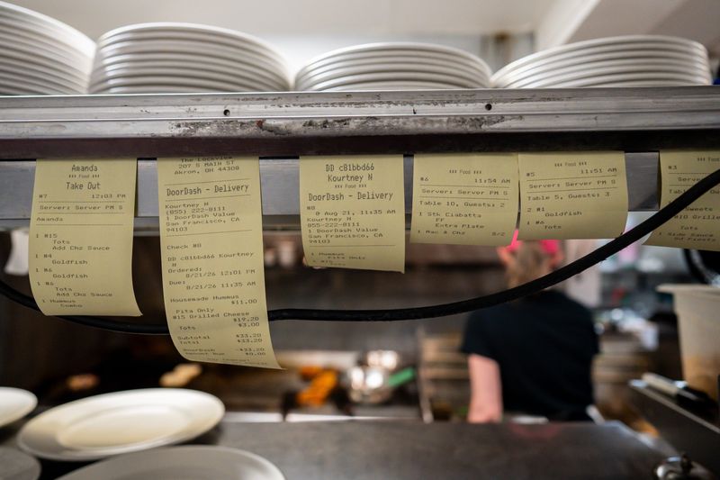Order tickets are seen in the window of the kitchen at The Lockview during lunch service, Aug. 21, 2026, in Akron, Ohio.