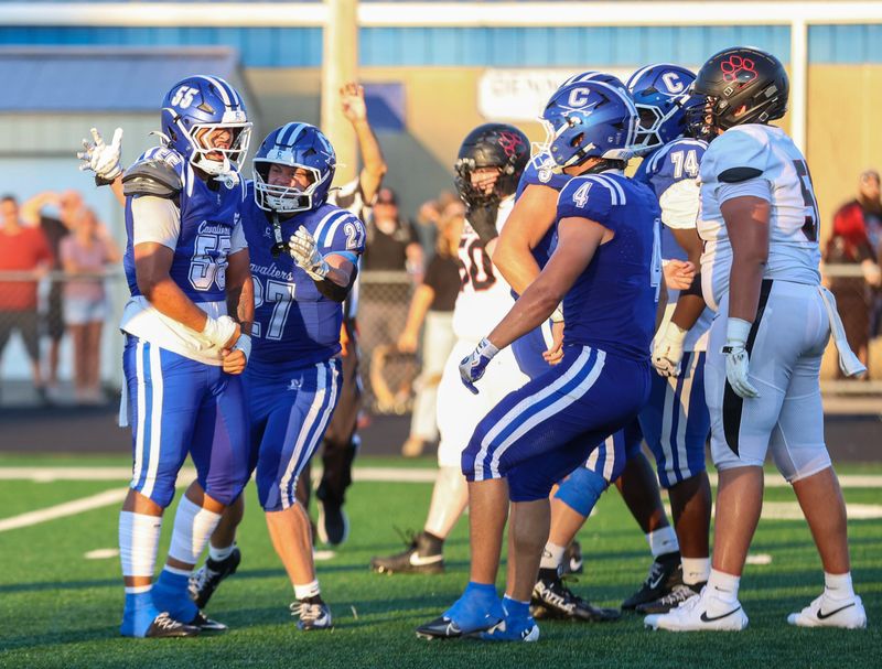 Chillicothe's Aydin Scales (55) celebrates with teammates Zeb Martin (27) and Trace McAllister (4) after a tackle for a loss during the Cavaliers' 34-0 win over Circleville on Aug. 21, 2026.