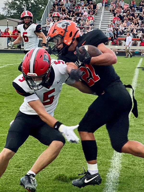 North Union's Wyatt Arver runs the football as Pleasant's Madden Queen attempts the tackle during a Week 1 high school game at North Union Aug. 21, 2026.