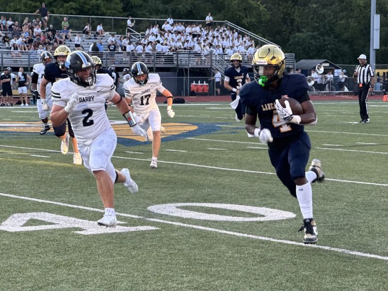 Lancaster senior running back Jahmeir Gordon runs away from a Hilliard Darby defender during the Gales' 20-15 nonconference loss on Friday, Aug. 21, 2026.