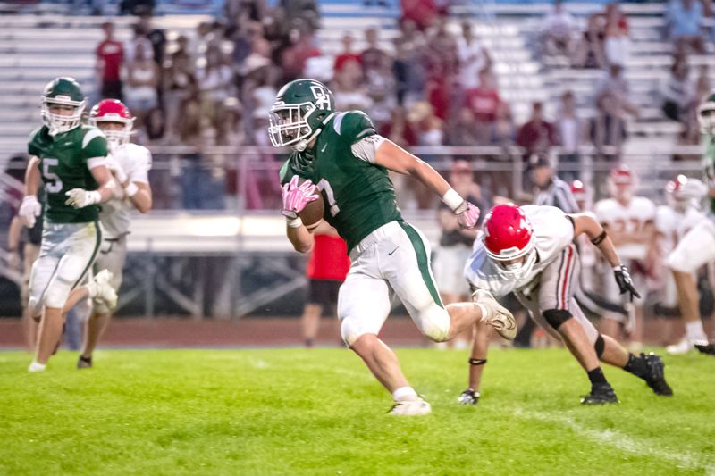 Oak Harbor's Micah Miller breaks a tackle and races for a touchdown.