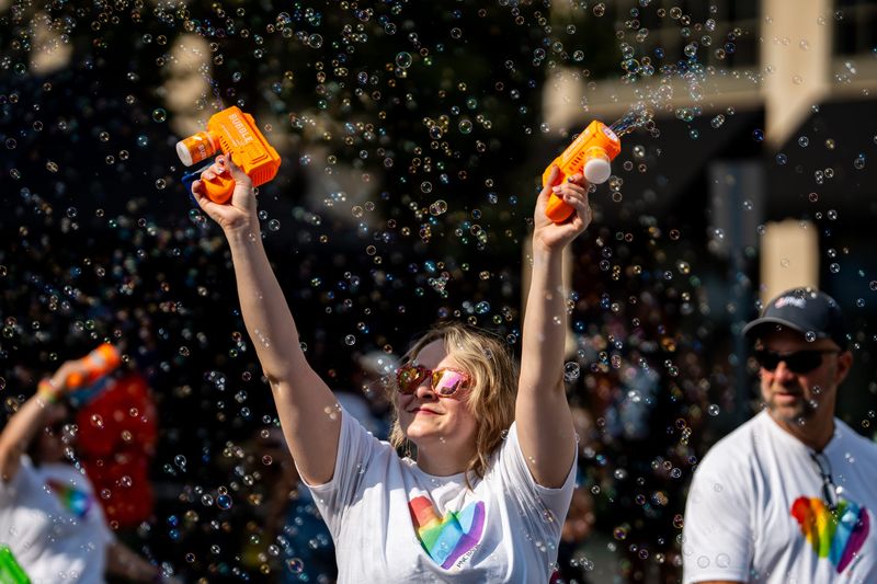 An attendee at the 10th Akron Pride Festival has fun with bubble machines Aug. 22, 2026, in Akron, Ohio.