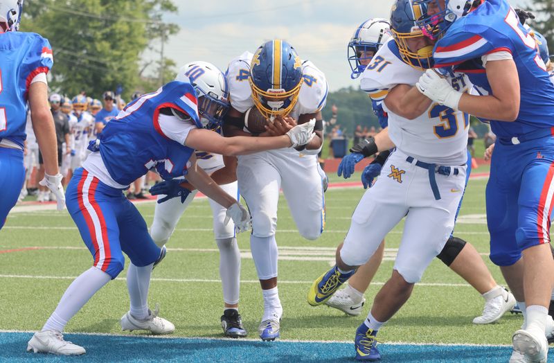 West Muskingum's Dente Tyson follows the block of Cooper McKenzie into the end zone during the visiting Tornadoes' 51-0 victory against Lakewood at Calhoun Memorial Field on Aug. 22, 2026.