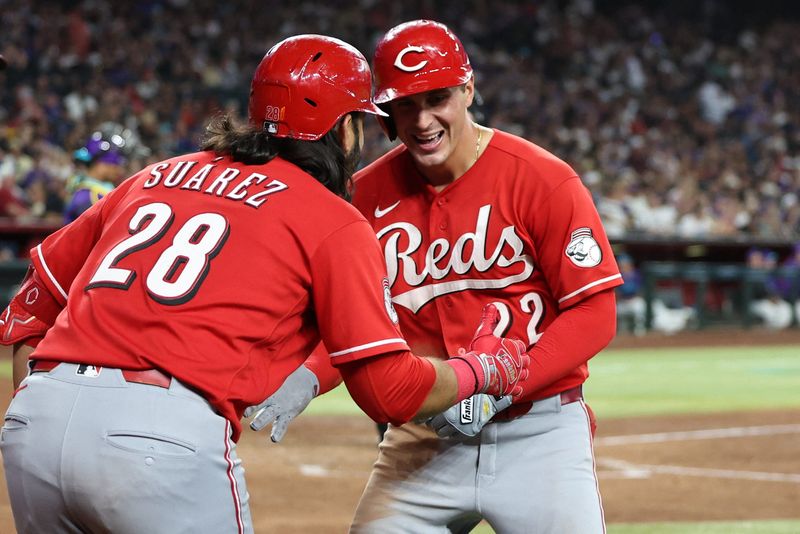 Cincinnati Reds outfielder JJ Bleday (22) celebrates with Cincinnati Reds designated hitter Eugenio Suarez after hitting a home run for the cycle against the Arizona Diamondbacks in the sixth inning at Chase Field.