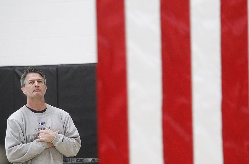 Former Olentangy Liberty wrestling coach Mark Marinelli stands for the national anthem before the Patriots' match at Dublin Coffman on Jan. 6, 2022.