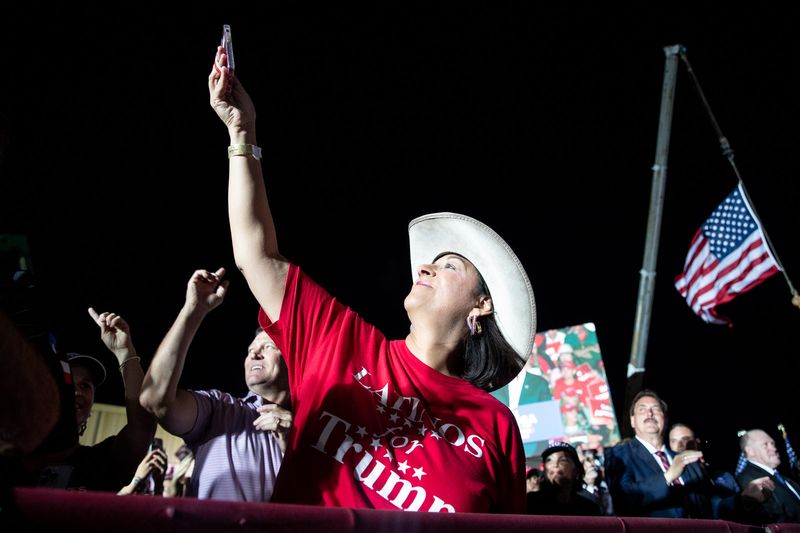 In this 2022 file photo, Bianca Garcia, president of the Latinos for Trump Organization, lifts her phone up for footage of Donald Trump at his rally at the Richard M. Borchard Regional Fairgrounds in Robstown.