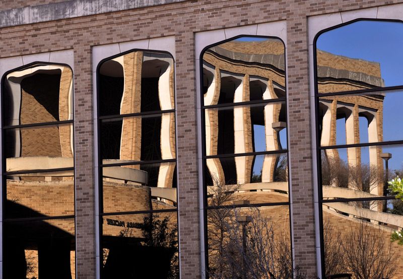 The Chapel on the Hill is reflected in the windows of the College of Biblical Studies at Abilene Christian University in 2018. The Dukes School of Finance has announced a new agreement for students seeking to become Chartered Financial Analysts.