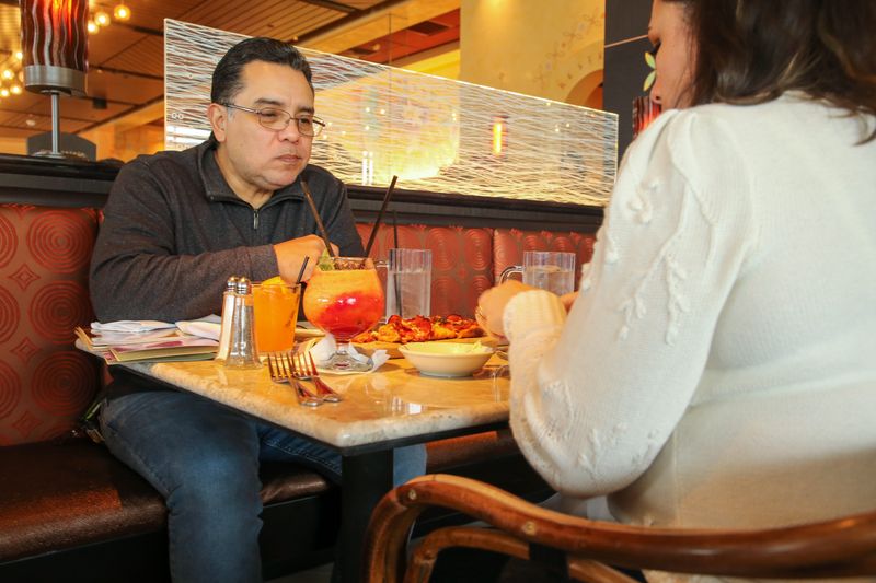 Albert Mata (left) and his wife Angel enjoy their lunch at The Cheesecake Factory at La Palmera mall Thursday, Dec. 22, 2022.