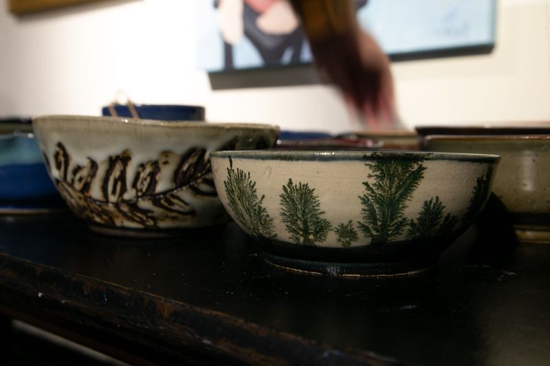 A guest reaches for a one-of-a-kind bowl at the 13th Souper Bowl at the Art Center of Corpus Christi on Feb. 16, 2023.