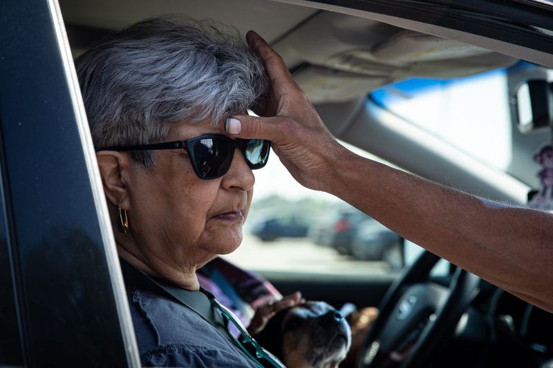Emma Vargas receives ashes and a blessing during All Saints' Episcopal Church's "ashes-to-go" event on Ash Wednesday, Feb. 22, 2023, in Corpus Christi, Texas.