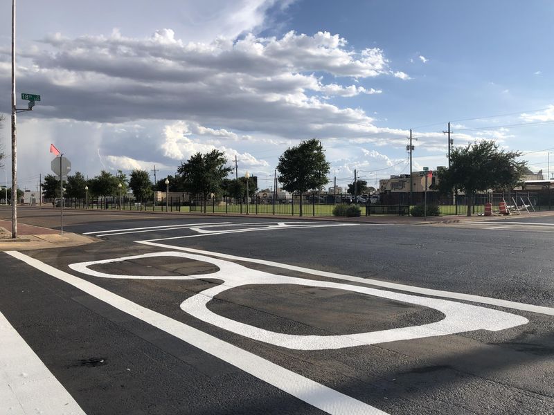 The cross walk now featuring images of Holly's iconic glasses is at 18th Street and Crickets Avenue, the intersection north of the Buddy Holly Center and the Buddy and Maria Elena Holly Plaza.