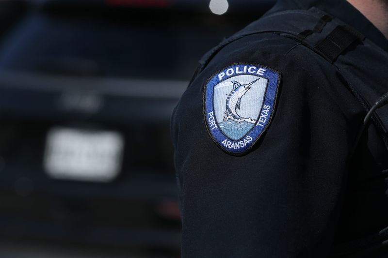 Port Aransas police detective Cody Clark eyes spring breakers at the city's beach Friday, March 17, 2023.