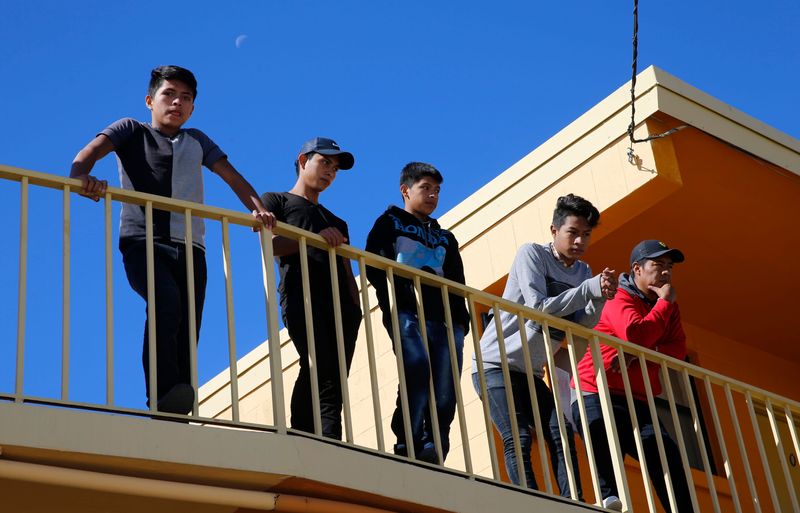 Recently released migrants move freely around the grounds of an El Paso motel as they await transportation to be united with relatives.