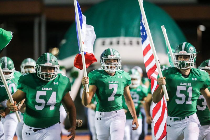 Jaakan Jurecek (7) and the Eldorado Eagles charge onto the field for their bidistrict playoff game against Haskell on Friday, Nov. 16, 2018, at San Angelo Stadium.