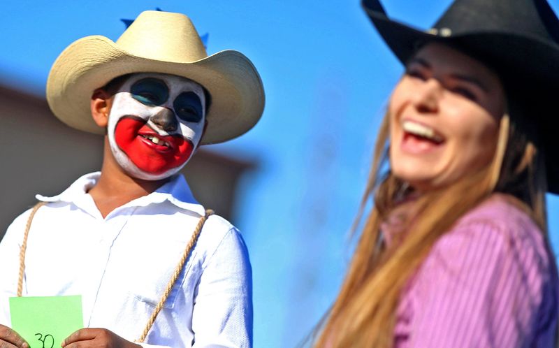 Kevin Wilkins, left, gets a laugh from Susannah Mann, right, after answering a question during the annual San Angelo Stock Show and Rodeo Jr. Rodeo Clown and Princess contest at Blair's Western Wear on Jan. 4, 2020.