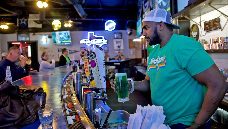 Jerrell Jones pours a green beer at Shenanigans Sports Bar for St. Patrick's Day on March 17, 2021.
