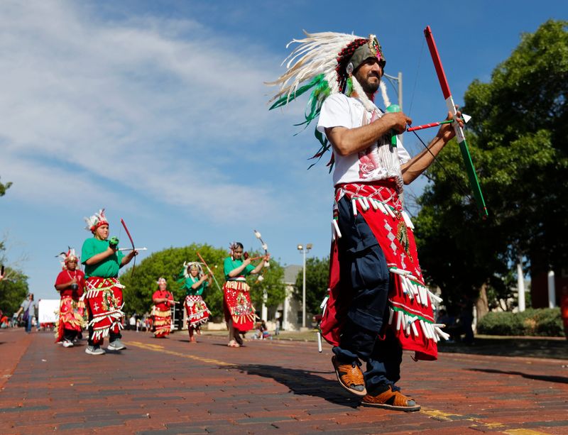 The Matachines dance group member Abraham Beltran  walks down the parade route. Lubbock's Cinco de Mayo parade traveled down Broadway from First Baptist Church to the Lubbock Memorial Civic Center Saturday morning, May 1, 2021. This year's theme was "!Flores y Colores!" Organizations, schools, youth, and families participated in this year's parade celebrating the cultural history and contributions of the Mexican American community.