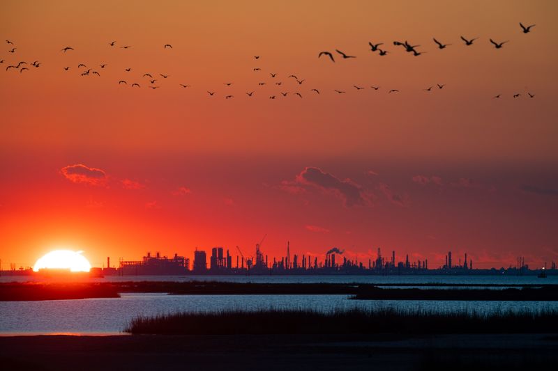 In this 2022 file photo, heavy industrial facilities lining the Port of Corpus Christi ship channel, in an area known as Refinery Row, are seen across Nueces Bay in Portland.
