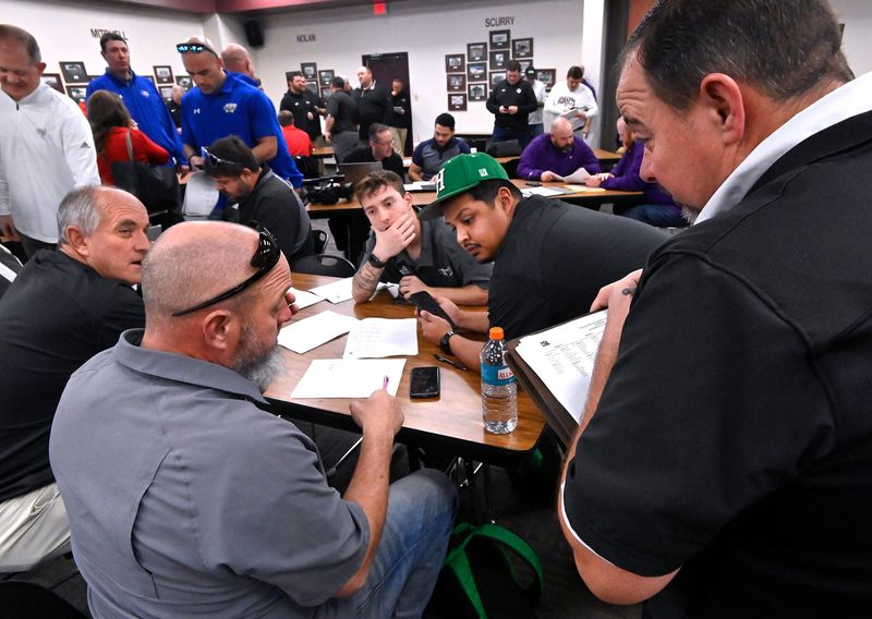 Coaches and administrative staff trade ideas and propositions as they iron-out high school football, basketball and volleyball schedules for the next two years during the UIL Realignment at Region 14 Education Service Center in Abilene Thursday Feb. 1, 2024.