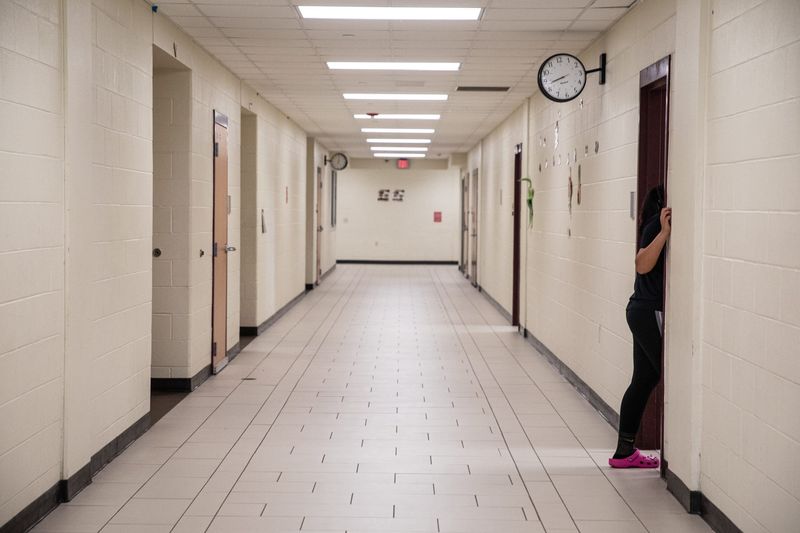 A student pokes her head into a classroom during a voluntary half-day at H.M. King Early College High School on Friday, Feb. 9, 2024, in Kingsville, Texas.