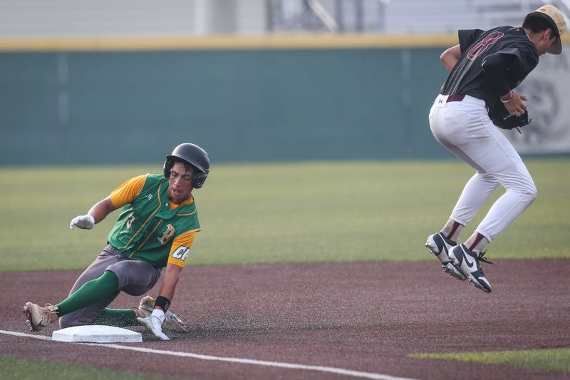 Bishop batter Jalen Arriaga slides safe onto third base as Tuloso-Midway Ozbie Buentello catches a ball thrown from the outfield during the Class 4A regional quarterfinal series at Cabaniss Baseball Field on Thursday, May 16, 2024, in Corpus Christi, Texas.