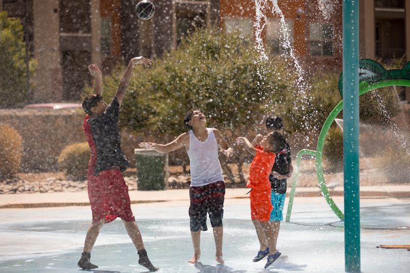 Kids play basketball cooling down at Chamizal Community Spray Park as temperatures hit triple digits again in El Paso on Thursday, June 13, 2024.