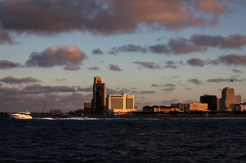 A yacht speeds past the downtown skyline during sunset in Corpus Christi Bay on Tuesday, June 25, 2024, in Corpus Christi, Texas.