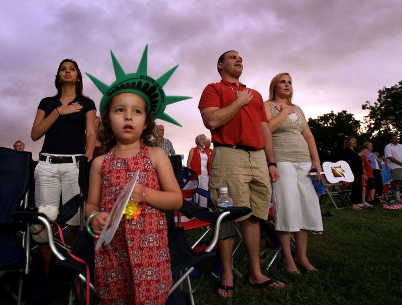 07/04/06- Rodolfo Gonzalez/AMERICAN-STATESMAN: Amanda Lucero, Julia Schoeneberg, 5, Caleb Brown and Rose Blezung, all of Austin, stand for the National Anthem played by the Austin Symphony during the opening of the H-E-B Austin Symphony July Fourth Concert & Fireworks held at Zilker Park, in Austin, Tx., on Tuesday, July 04, 2006.	0704fourthspast
