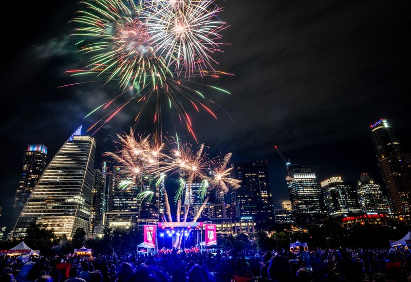 Attendees watch fireworks above the skyline during the Austin Symphony Orchestra July 4th Concert and Fireworks at Vic Mathias Shores, July 4, 2024. The show celebrated its 47th year.