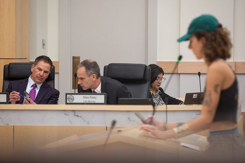 In this 2024 file photo, City Manager Peter Zanoni, left, leans over to speak with City Attorney Miles Risley during a City Council meeting.