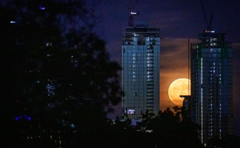 The super blue moon rises between skyscrapers on the Austin, Texas, skyline, Aug. 19, 2024. The super blue moon is a rare occurrence. The moon is close in its orbit to earth (making it a "super" moon) and is the fourth full moon of the summer season (making it a "blue" moon).