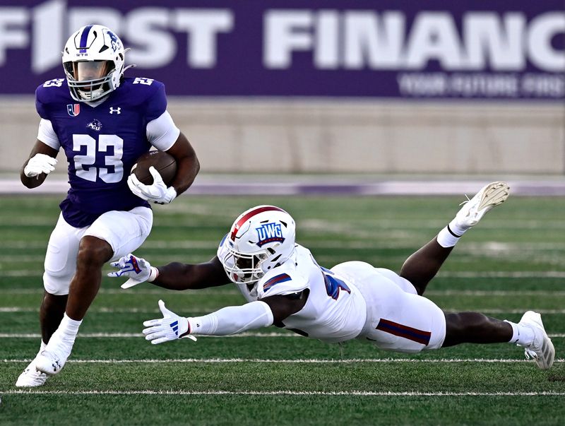 ACU running back Isaiah Johnson sprints through the outstretched hands of West Georgia linebacker Jay Carter during Saturday’s home opener at Wildcat Stadium Sept. 7, 2024. Final score was 38-24, ACU.