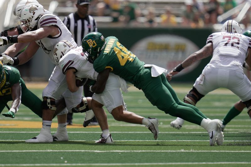 Sep 17, 2022; Waco, Texas, USA; Texas State Bobcats running back Lincoln Pare (22) is tackled by Baylor Bears linebacker Tony Anyanwu (46) during the second half at McLane Stadium. Mandatory Credit: Chris Jones-USA TODAY Sports