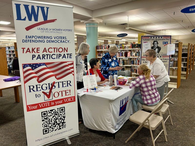 The League of Women Voters sets up a booth for National Voter Registration Day inside the Wichita Falls Public Library on Tuesday, Sept. 17, 2024.