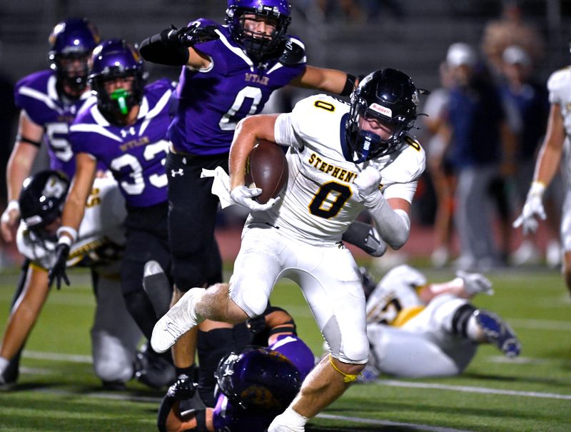 Stephenville running back Sawyer Wilkerson scrambles away from the Wylie defense during Friday’s game in Abilene Sept. 20, 2024. Final score was 49-27, Stephenville.
