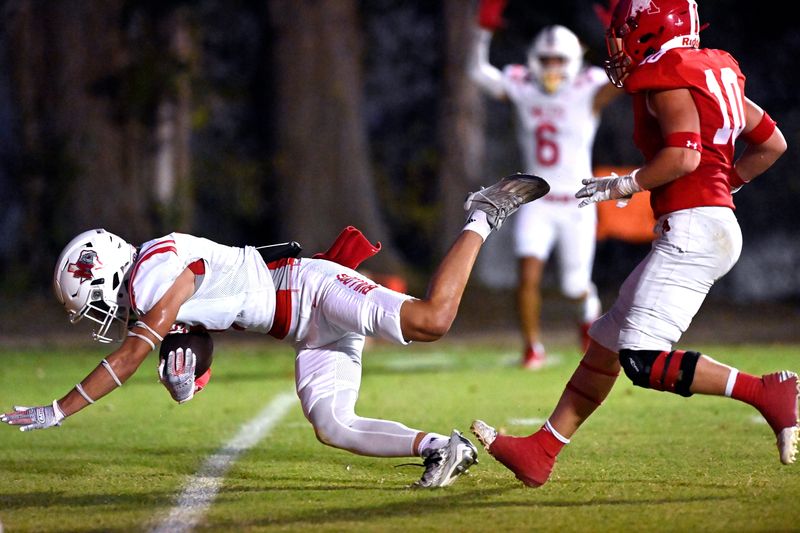 Miles wide receiver Keagan Walz dives into the end zone for a touchdown as Albany center back Will Barrett follows during Friday’s game in Albany Oct. 11, 2024. Final score was 47-15, Albany.