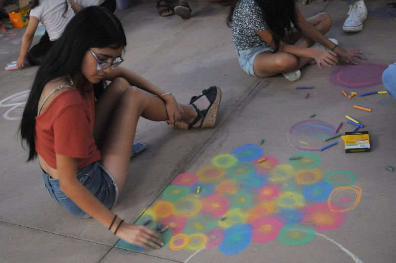 Kitzea Armas finished her drawing at the 2024 Chalk the Block preview event held on Friday, Oct. 11, in El Paso's Arts District. Festivities run from Oct. 11-13 and include live entertainment, chalk art, and family-friendly events.