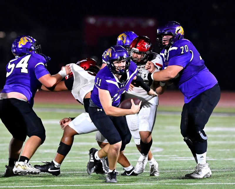 Wylie quarterback Bear Meng breaks from the line of scrimmage for a scramble against Lubbock-Cooper during Friday’s game in Abilene Nov. 1, 2024. Final score was 22-6, Wylie.