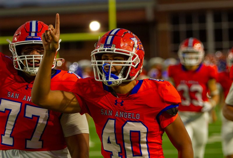 San Angelo Central football's Tu'uta Kalamafoni (77) and Erik Kuniyuki (4) run out of the tunnel before a matchup against Odessa at San Angelo Stadium on Friday, Nov. 1.