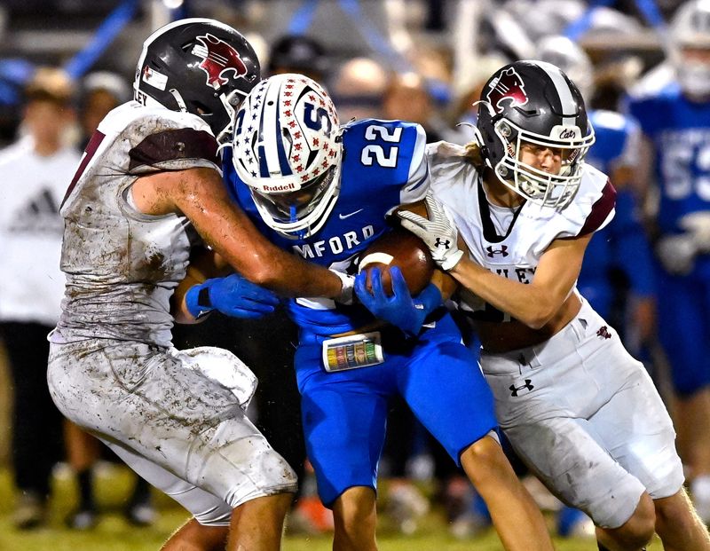 Hawley linebacker Keagan Ables (left) and teammate Brayden Williams sandwich Stamford receiver Caden Moreno in a tackles during Friday’s game in Stamford Nov. 8, 2024. Final score was 38-22, Stamford.