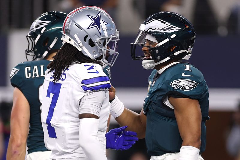 ARLINGTON, TEXAS - NOVEMBER 10: Trevon Diggs #7 of the Dallas Cowboys talks with Jalen Hurts #1 of the Philadelphia Eagles after scoring a touchdown during the third quarter at AT&T Stadium on November 10, 2024 in Arlington, Texas. (Photo by Sam Hodde/Getty Images)