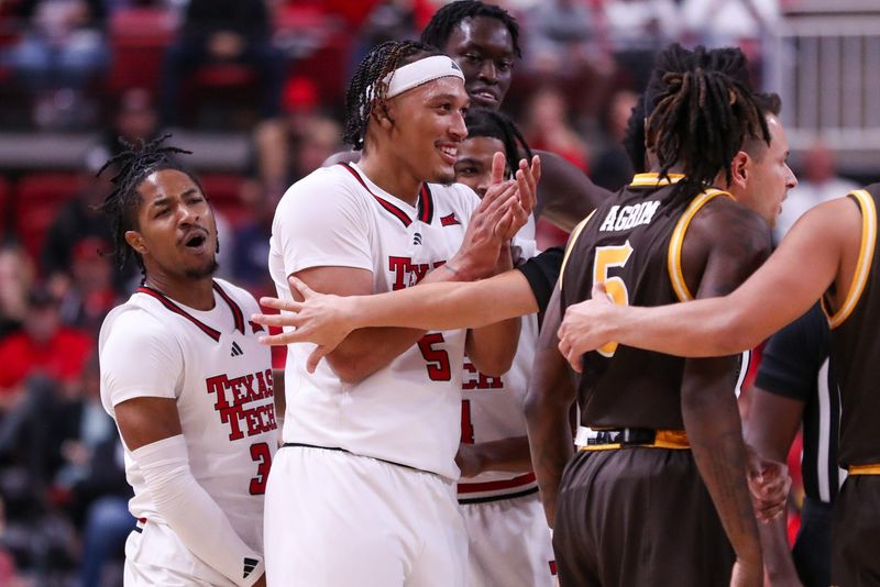 Texas Tech players Darrion Williams and Elijah Hawkins (left) react after a scuffle with Wyoming during a non-conference basketball game, Wednesday, Nov. 13, 2024, in United Supermarkets Arena.