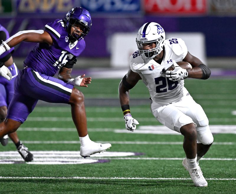 Abilene Christian running back Jordon Vaughn slips past Tarleton State linebacker A.J. Owens during Saturday’s game in Stephenville Nov. 16, 2024. Final score was 35-31, ACU.