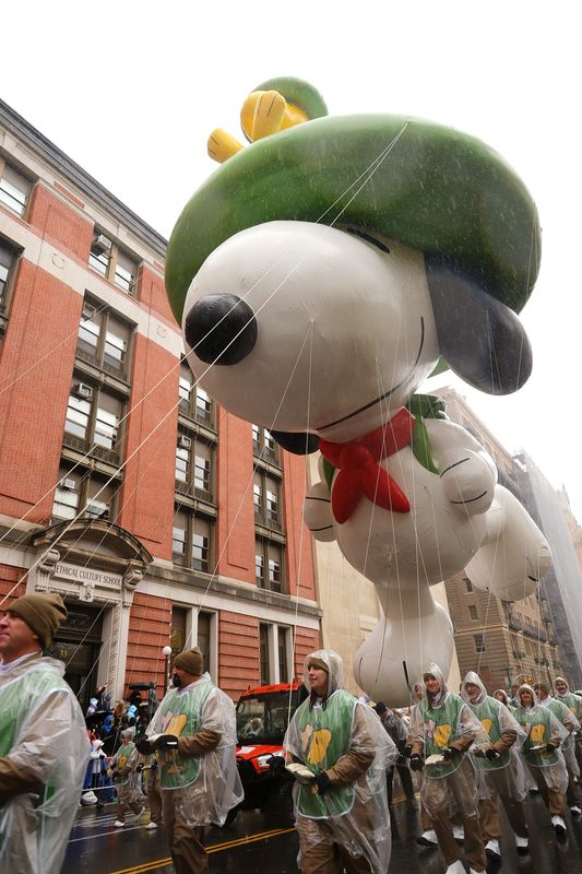 NEW YORK, NEW YORK - NOVEMBER 28: Parade participants are seen with the Snoopy balloon during the 2024 Macy's Thanksgiving Day Parade on November 28, 2024 in New York City. (Photo by Michael Loccisano/Getty Images)