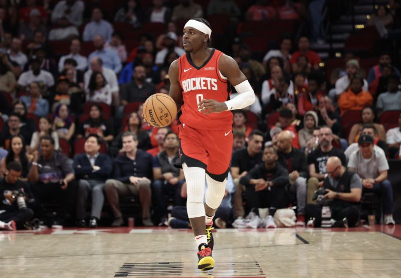 Nov 11, 2024; Houston, Texas, USA; Houston Rockets guard Aaron Holiday (0) dribbles against the Washington Wizards in the second quarter at Toyota Center. Mandatory Credit: Thomas Shea-Imagn Images