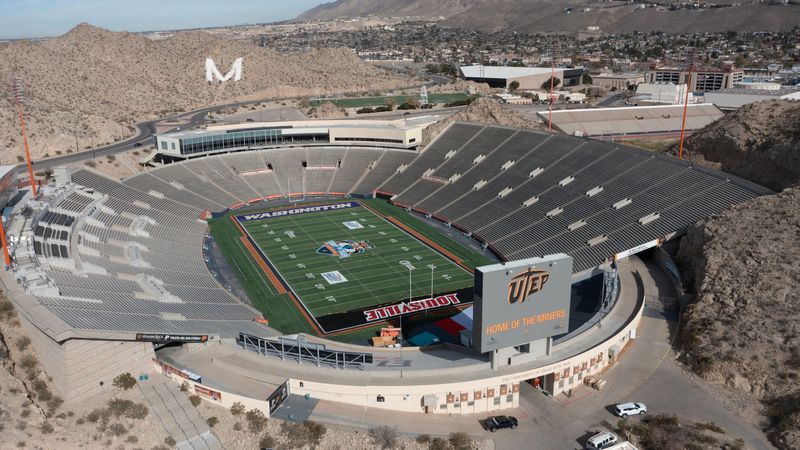 The Sun Bowl Stadium is painted with university names - Washington and Louisville - and sponsor logos for the Tony the Tiger Sun Bowl on Tuesday, Dec. 31, in El Paso, Texas. The nationally-televised game is a marquee event showcasing the Sun City's culture, heritage and ties to Fort Bliss, an important U.S. Army post.