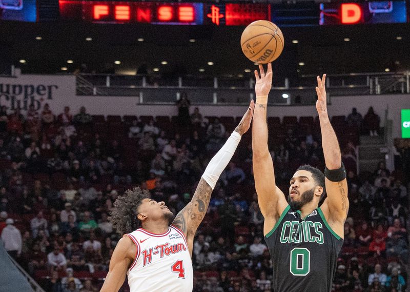 Jan 21, 2024; Houston, Texas, USA; Boston Celtics forward Jayson Tatum (0) shoots against Houston Rockets guard Jalen Green (4) in the second half at Toyota Center. Mandatory Credit: Thomas Shea-USA TODAY Sports