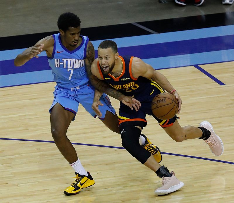 May 1, 2021; Houston, Texas, USA; Golden State Warriors guard Stephen Curry (30) drives against Houston Rockets guard Armoni Brooks (7) during the second quarter at Toyota Center. Mandatory Credit: Bob Levey /POOL PHOTOS-USA TODAY Sports