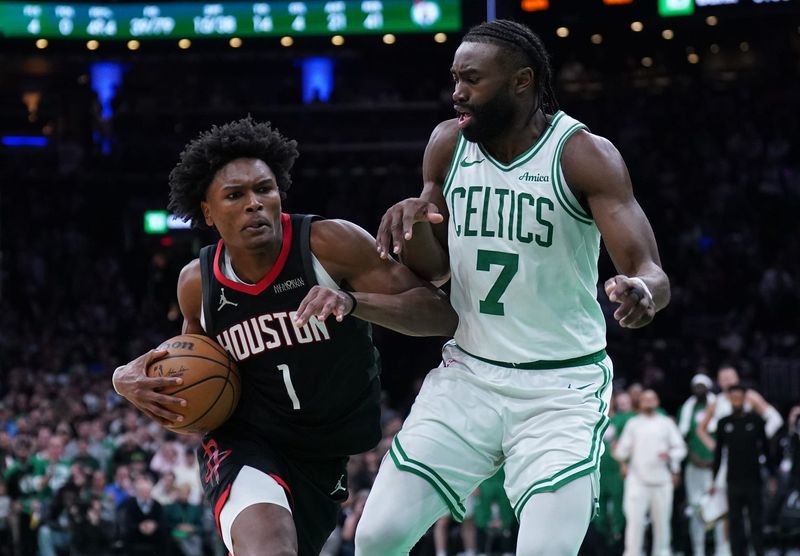 Jan 27, 2025; Boston, Massachusetts, USA; Houston Rockets forward Amen Thompson (1) drives the ball to the basket against Boston Celtics guard Jaylen Brown (7) in the last seconds of then game at TD Garden. Mandatory Credit: David Butler II-Imagn Images